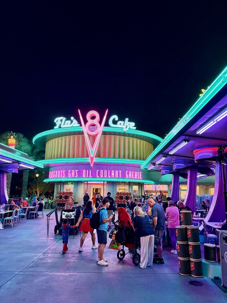 Flo's V8 Cafe glowing in neon at night in Cars Land