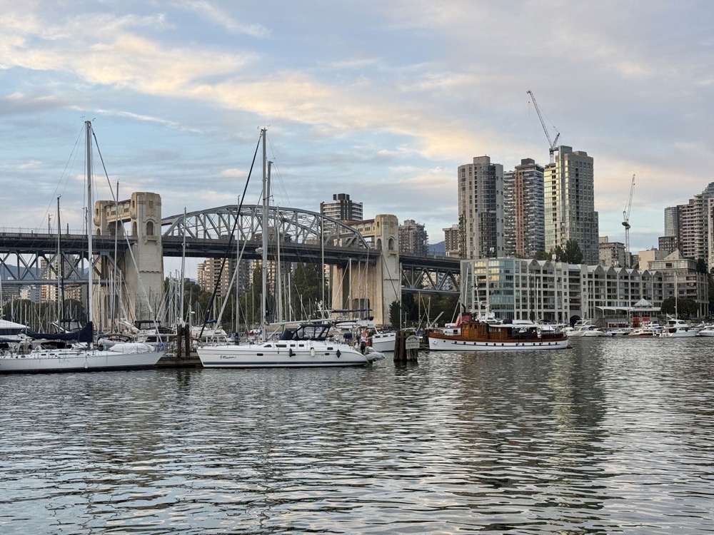 Boats in the marina at Granville Island with Vancouver's skyline behind
