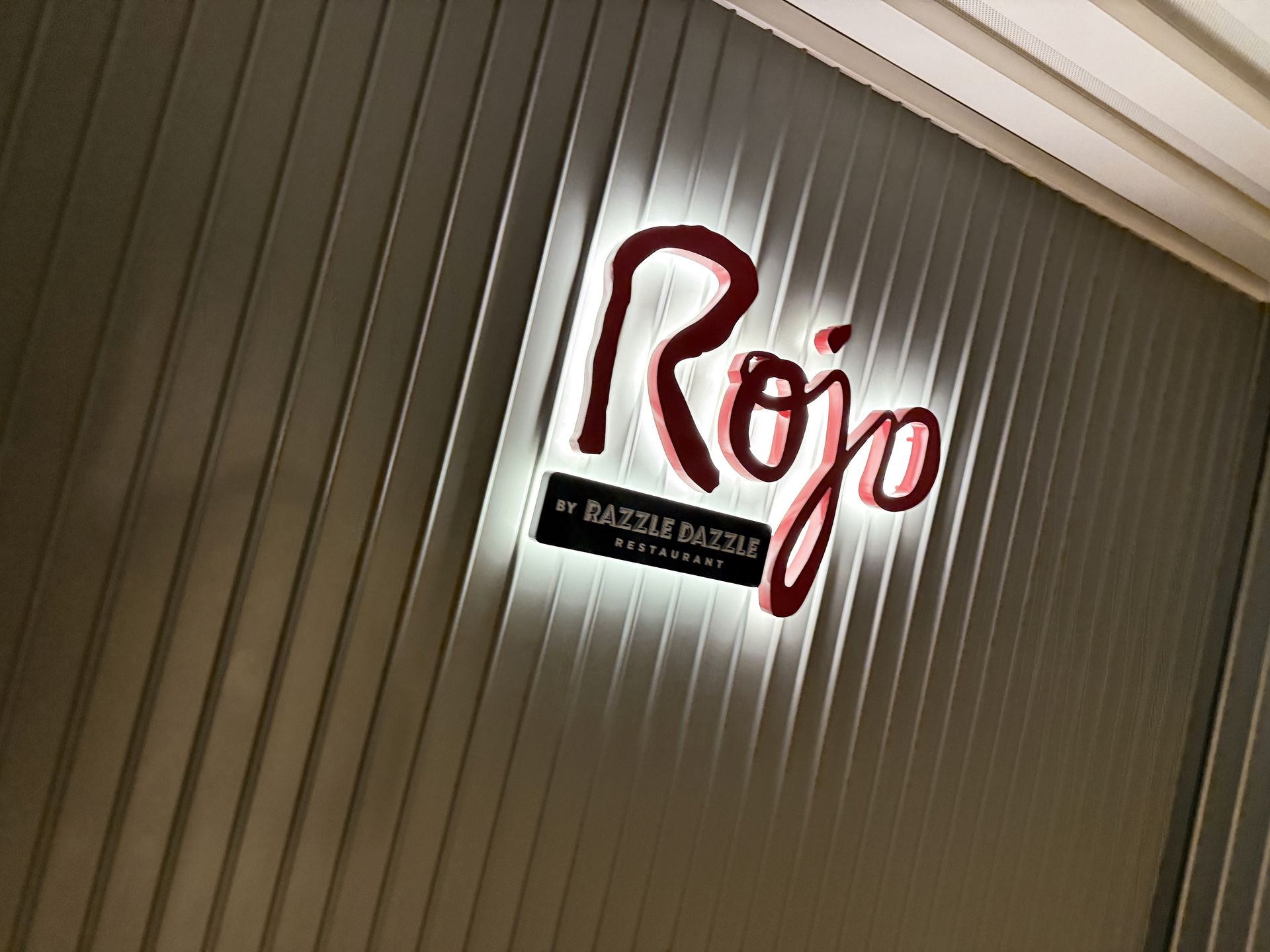 Rojo by Razzle Dazzle restaurant sign on Virgin Voyages Brilliant Lady