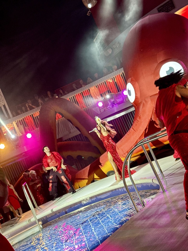 Performers on the pool deck during Scarlet Night on Brilliant Lady