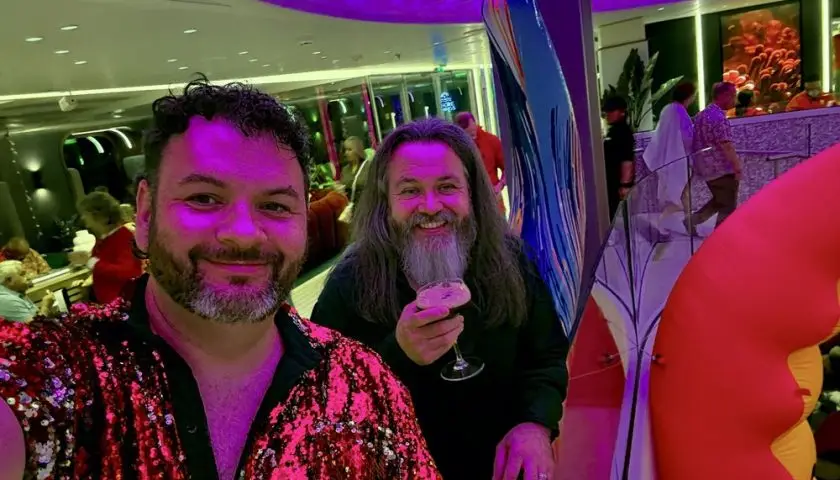 Kieran and Phil dressed in red for Scarlet Night on Virgin Voyages