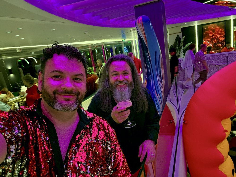 Kieran and Phil dressed in red for Scarlet Night on Virgin Voyages