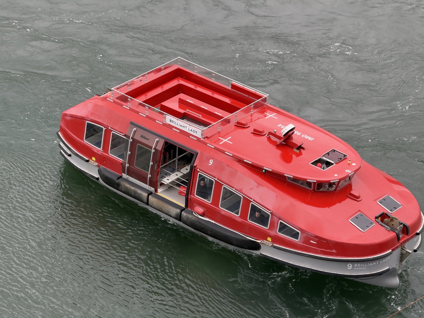 Brilliant Lady's red tender boat on the water at Juneau, Alaska