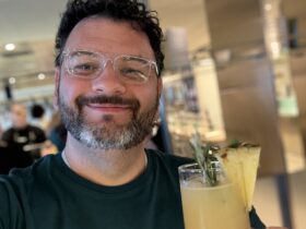 Kieran with a cocktail at one of the bars on Resilient Lady