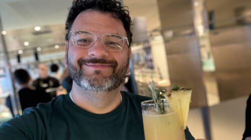 Kieran with a cocktail at one of the bars on Resilient Lady