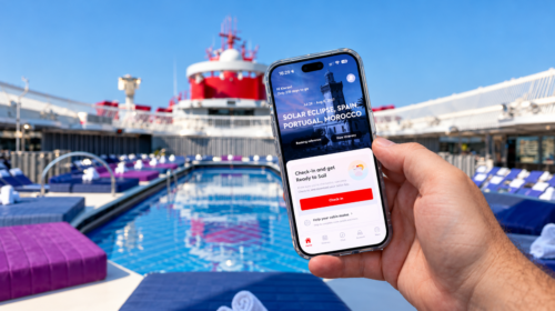 Holding the Virgin Voyages app on a phone by the pool on a Virgin Voyages ship