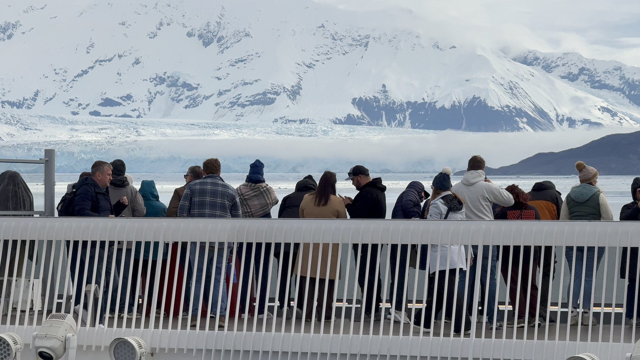 Sailors lining the rail of Brilliant Lady to watch the glacier on a scenic cruising day in Alaska