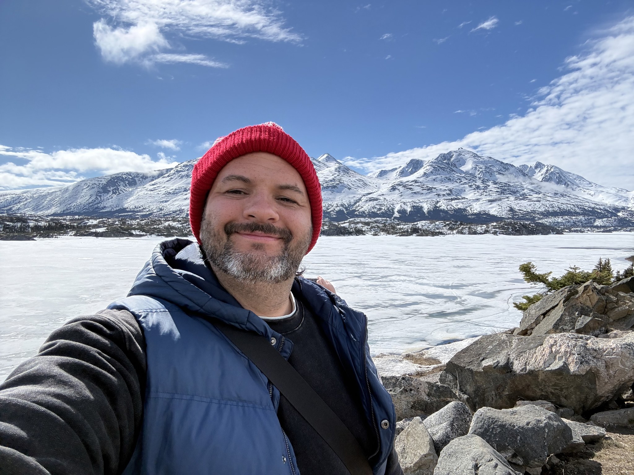 Kieran in a red hat in the snow at the White Pass summit, Skagway excursion