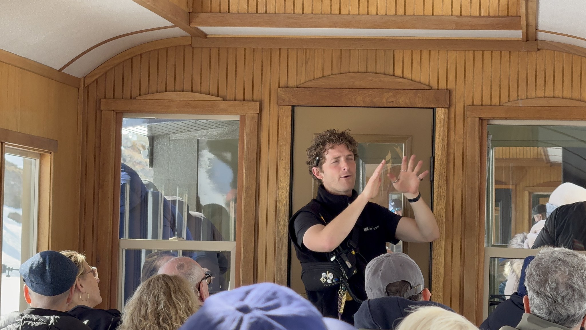 Guide giving commentary inside a vintage White Pass and Yukon Route railway carriage