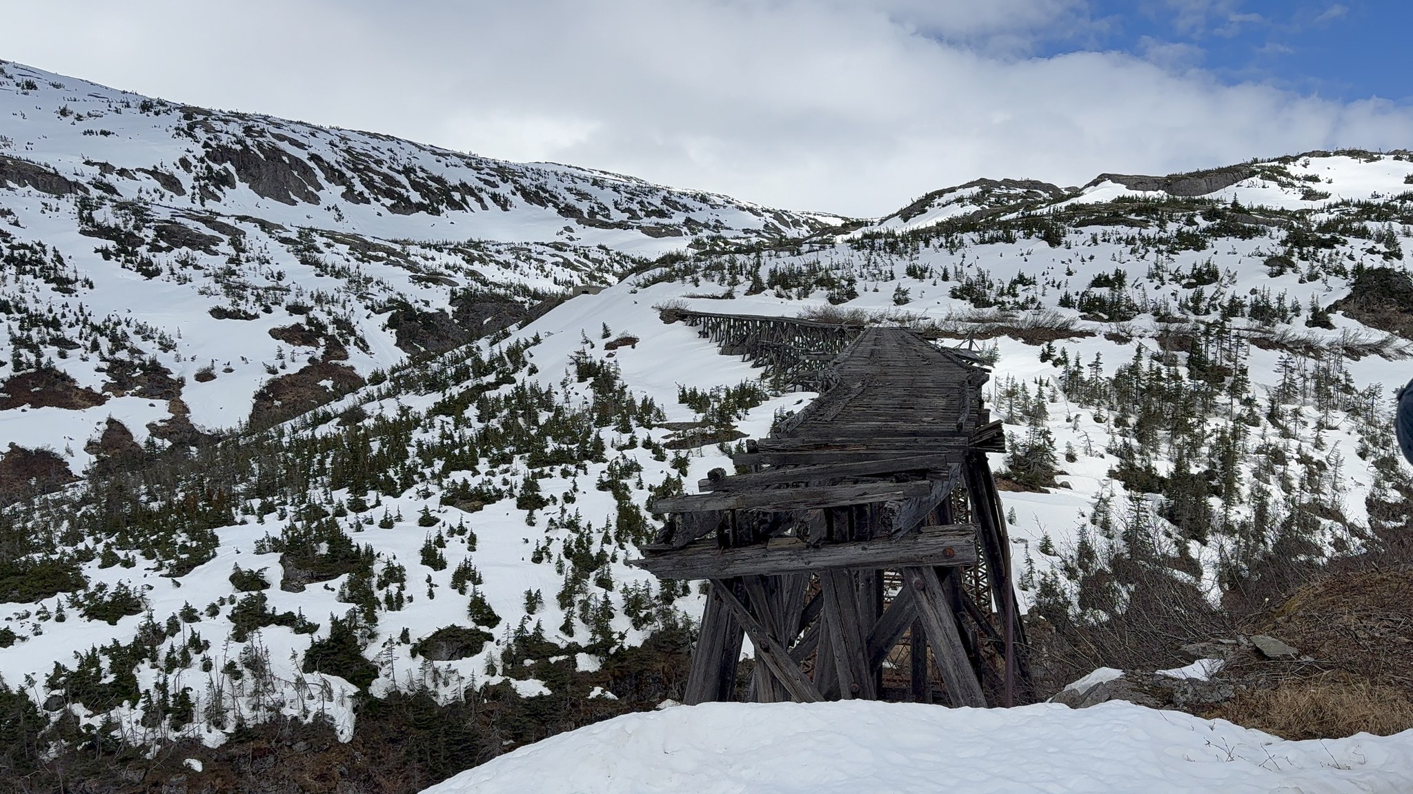Snowy valley and old trestle seen from the White Pass and Yukon Route railway