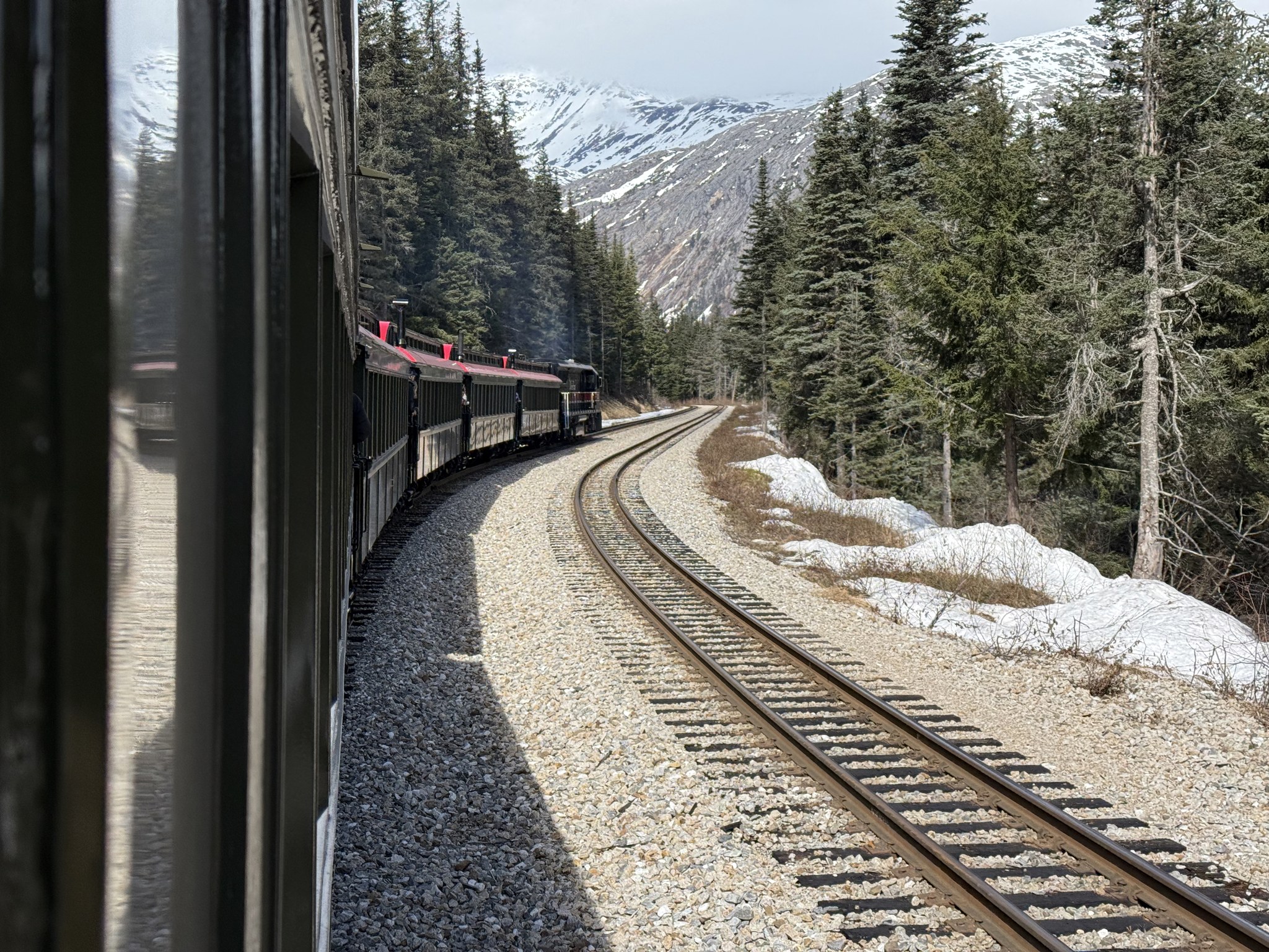 White Pass and Yukon Route train curving through snowy forest
