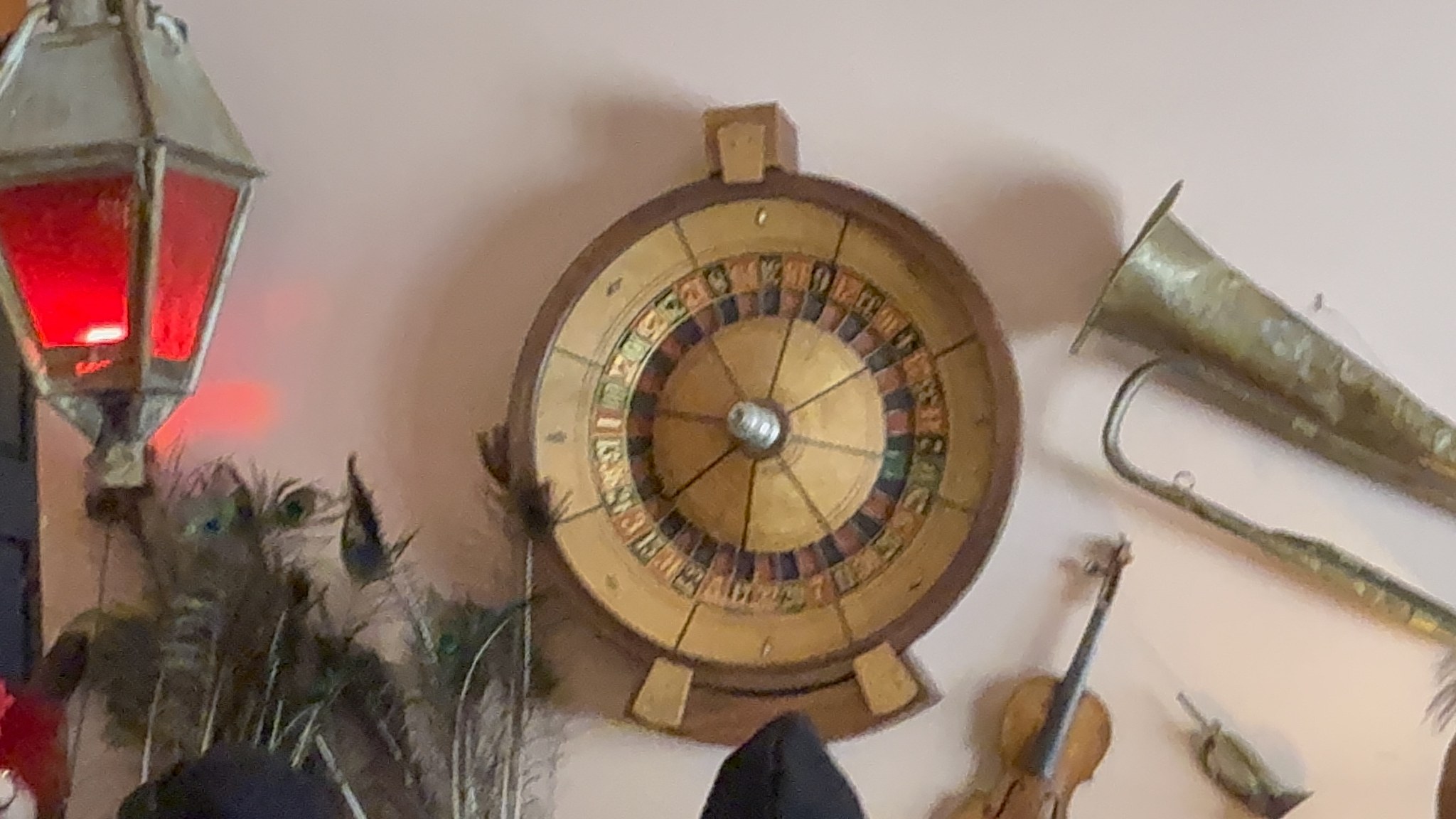Roulette wheel and brass horn on the wall of the Red Onion Saloon, Skagway
