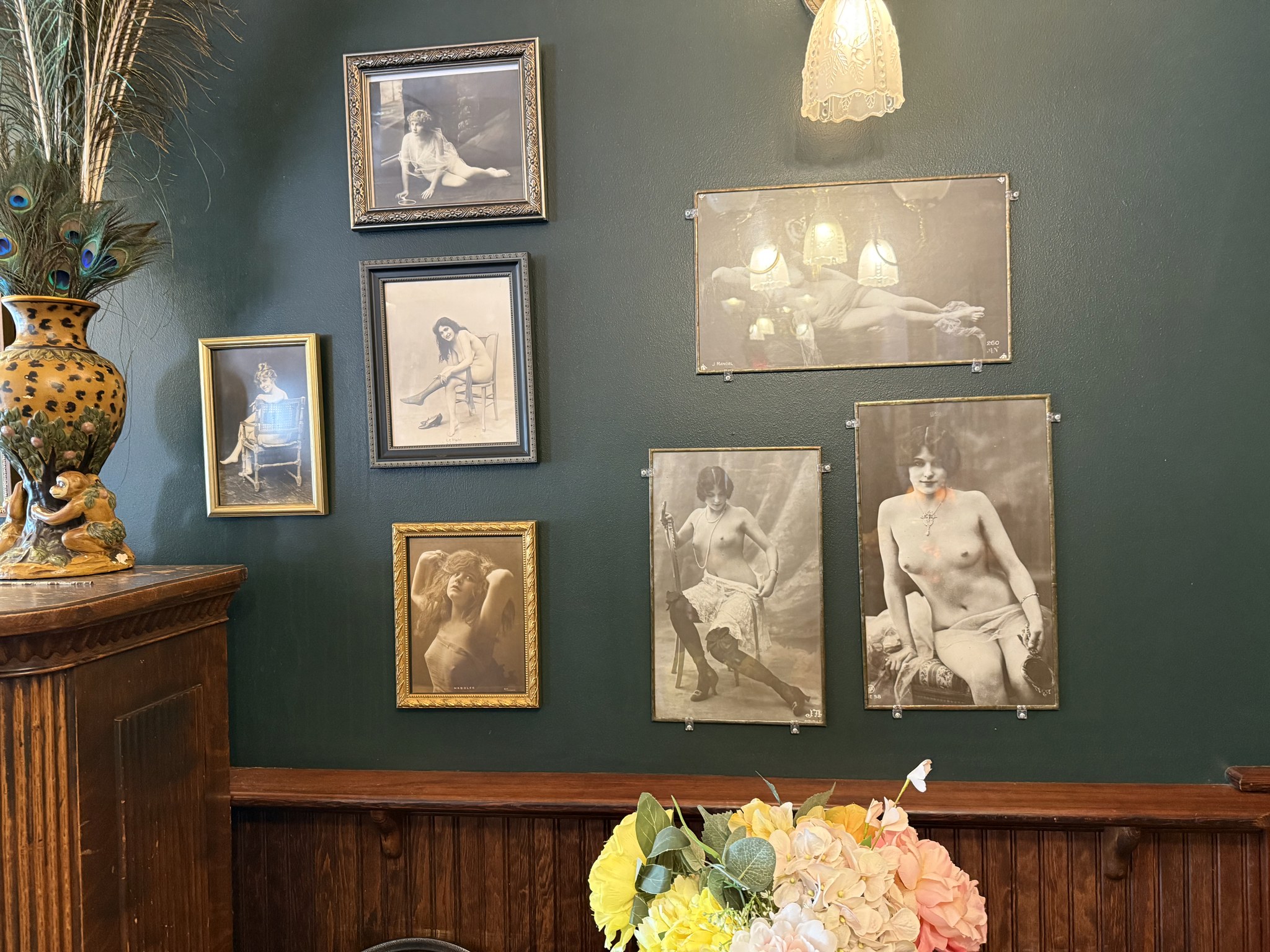 Vintage portraits on the teal walls of the Red Onion Saloon upstairs rooms