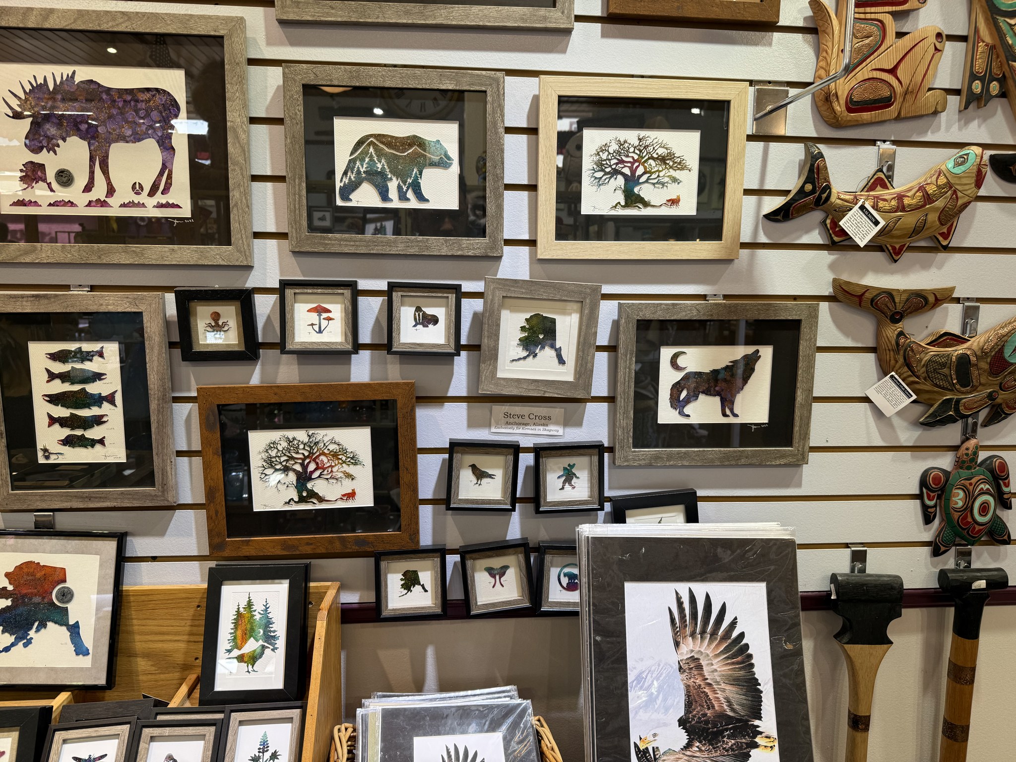 Framed Alaska wildlife and Native-inspired art prints in a Skagway gallery