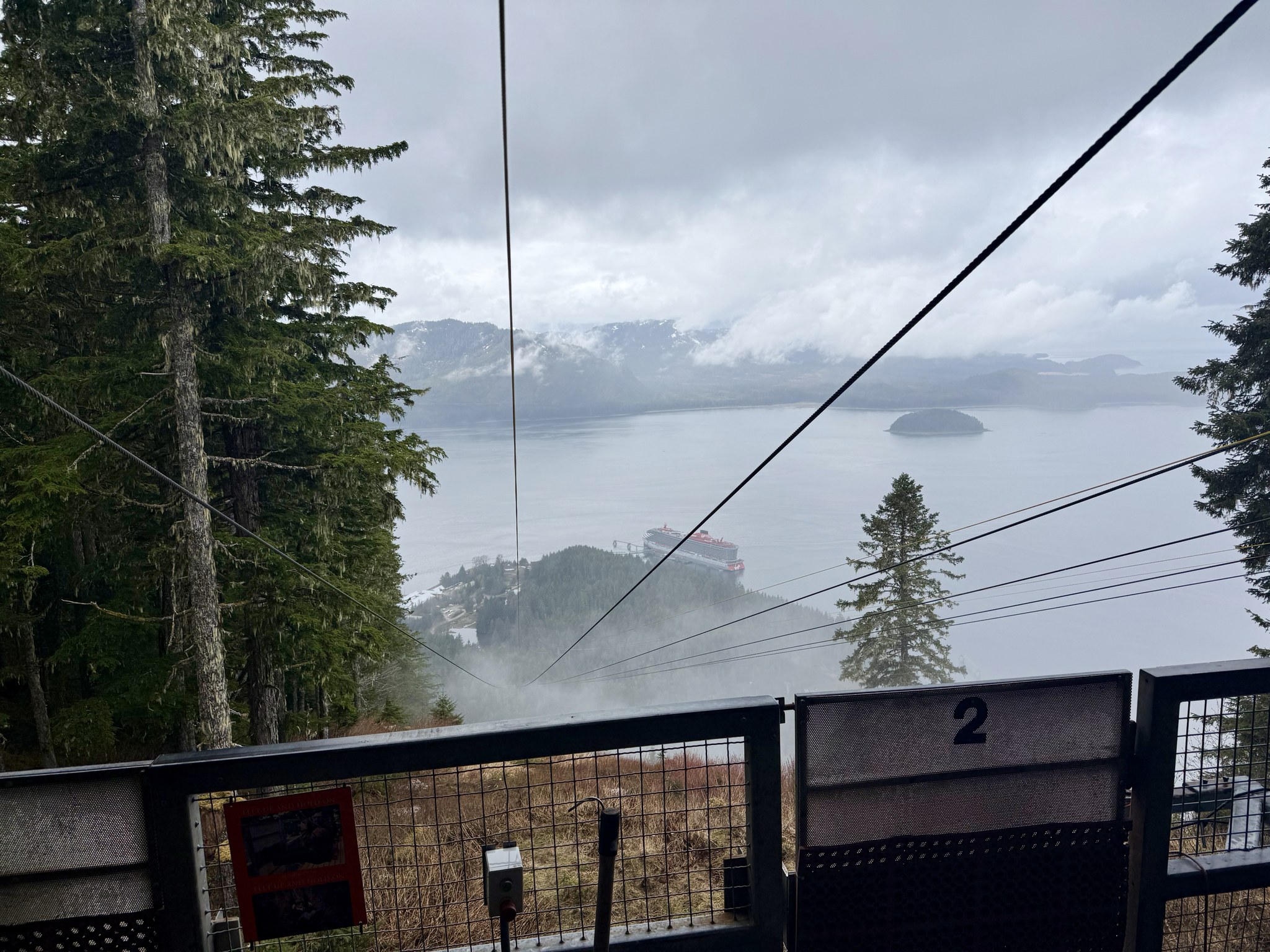 ZipRider zip line cables running down the mountain through the fog at Icy Strait Point
