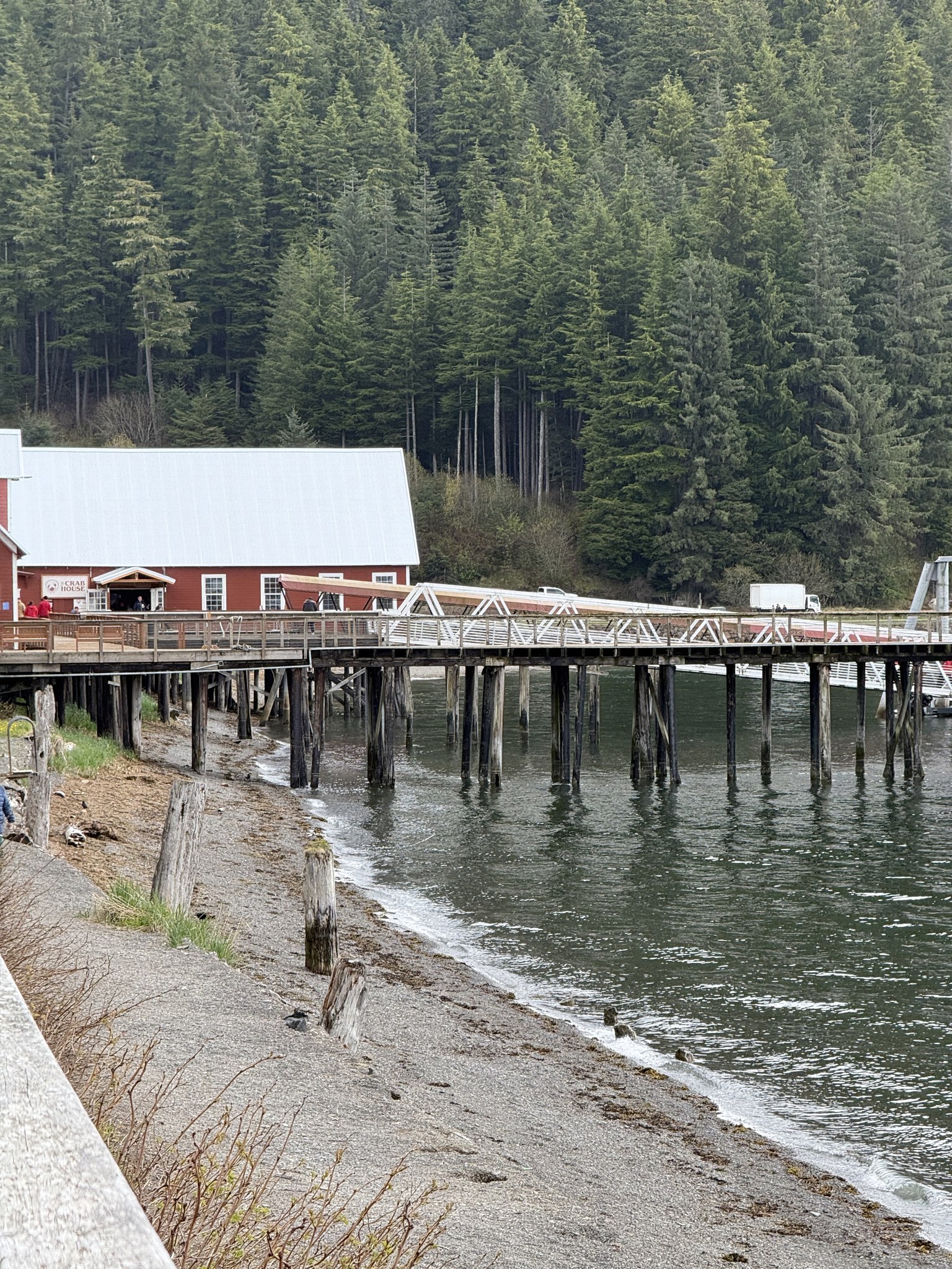 Red cannery building on stilts over the water at Icy Strait Point