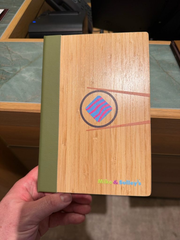 Disney Adventure Mike & Sulley's sushi menu cover, March 2026