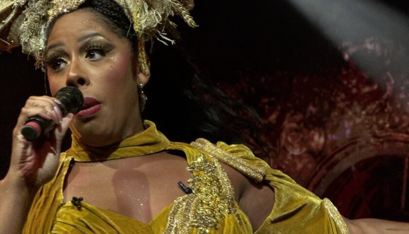 A performer in a gold gown and headdress on Resilient Lady