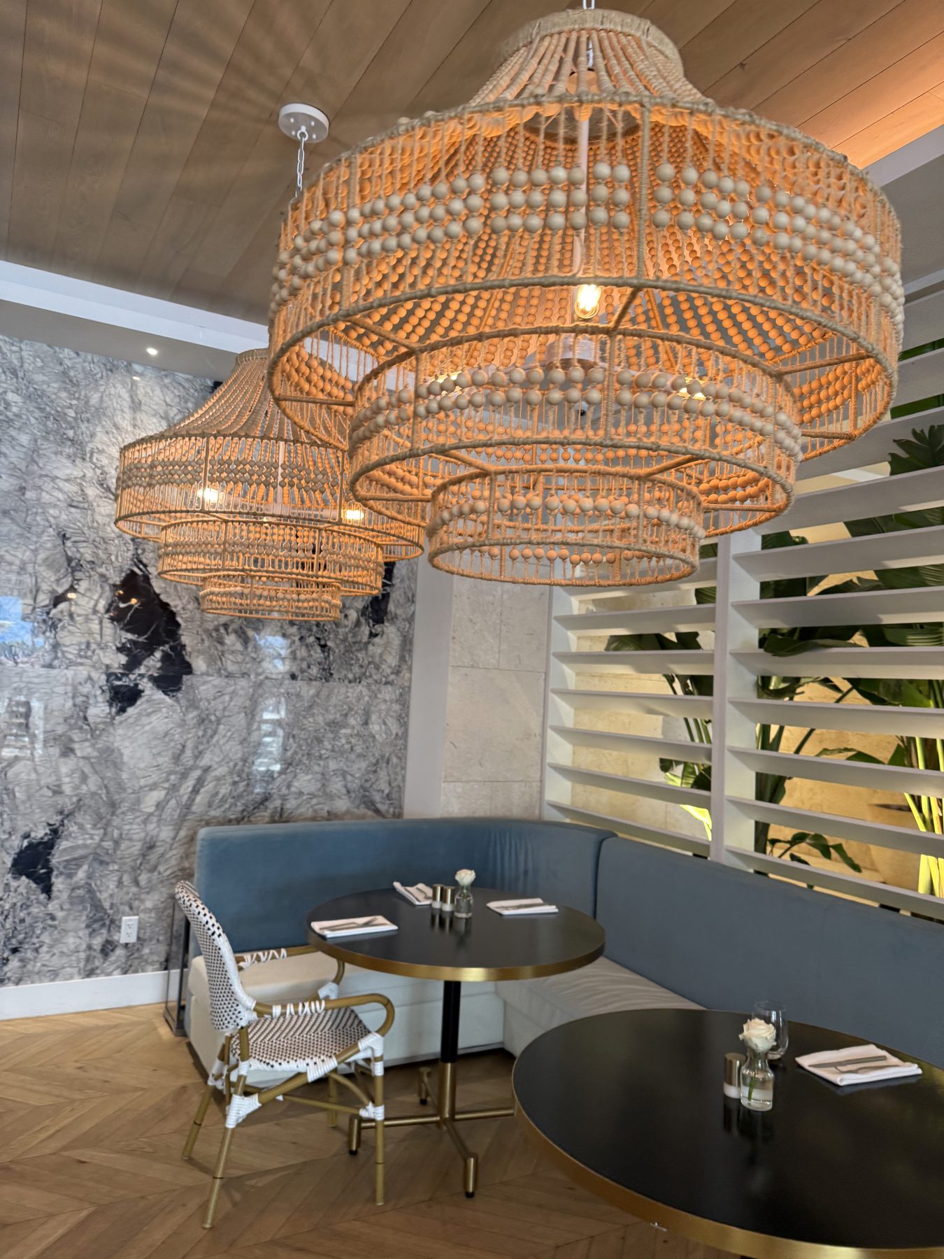 The lobby lounge with rattan chandeliers at Grand Beach Hotel, Miami Beach