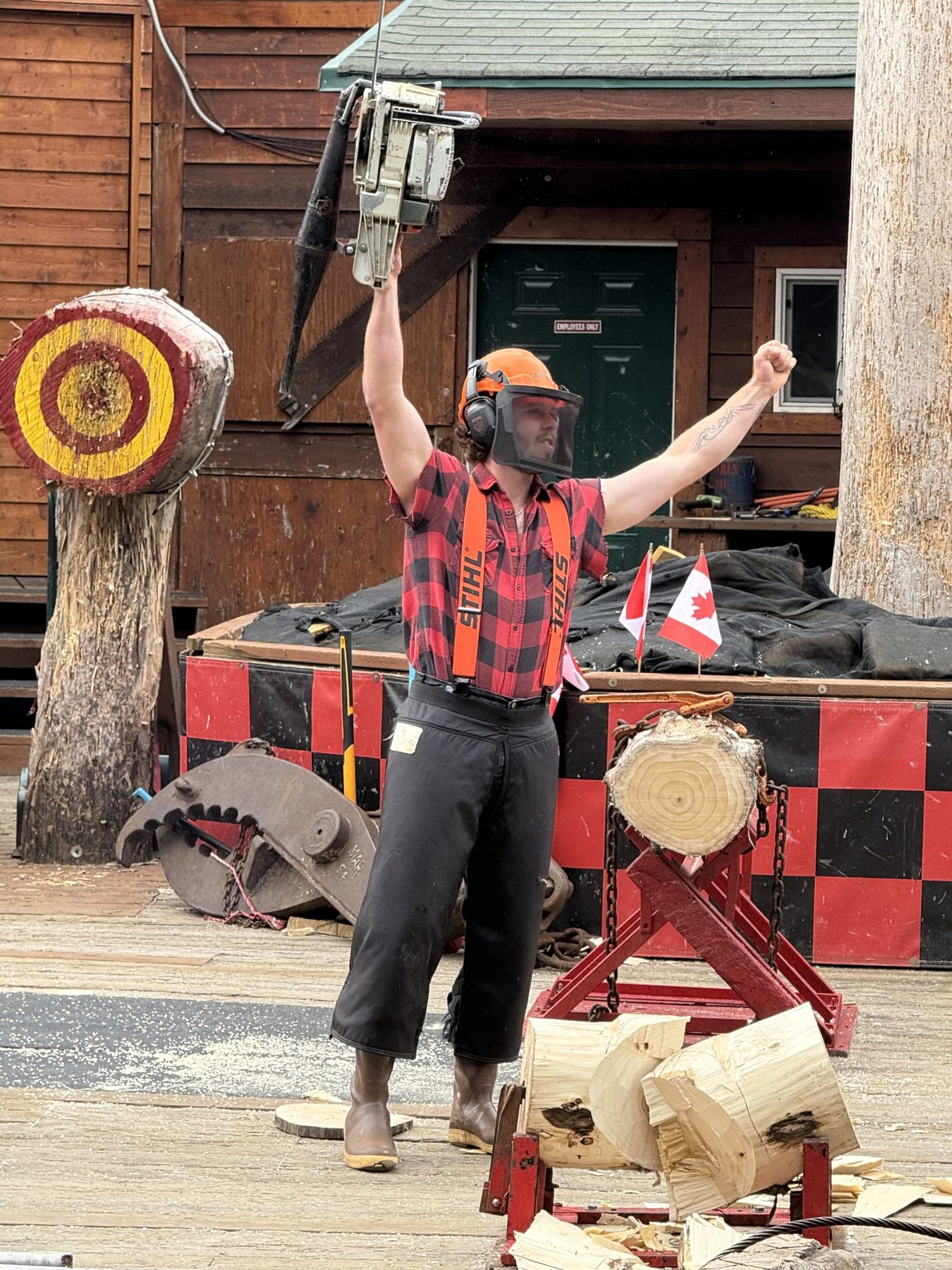 A lumberjack celebrating with a chainsaw at the Great Alaskan Lumberjack Show