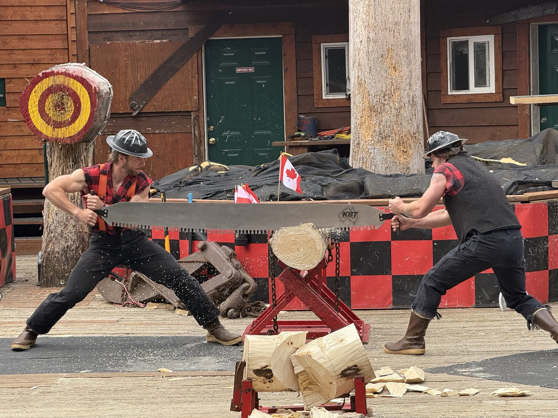 Two lumberjacks racing with a crosscut saw at the Great Alaskan Lumberjack Show