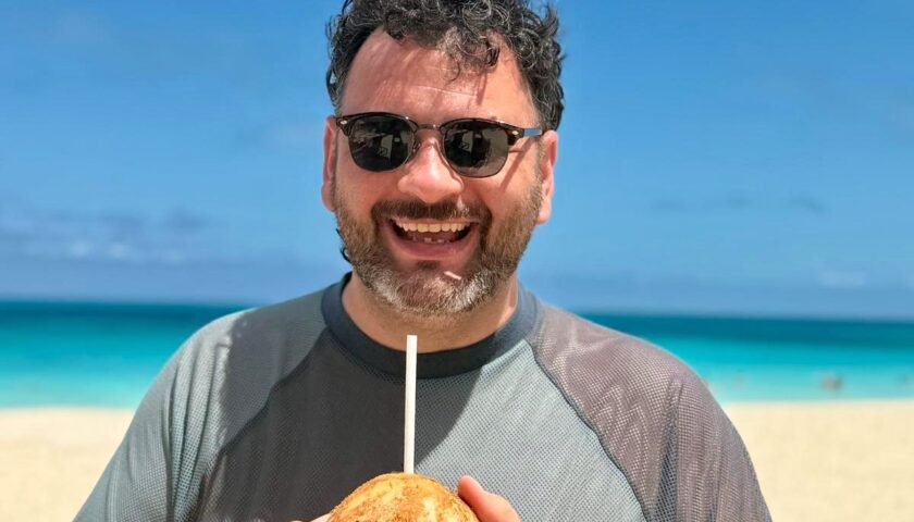 Kieran with a fresh coconut on the beach at Bimini