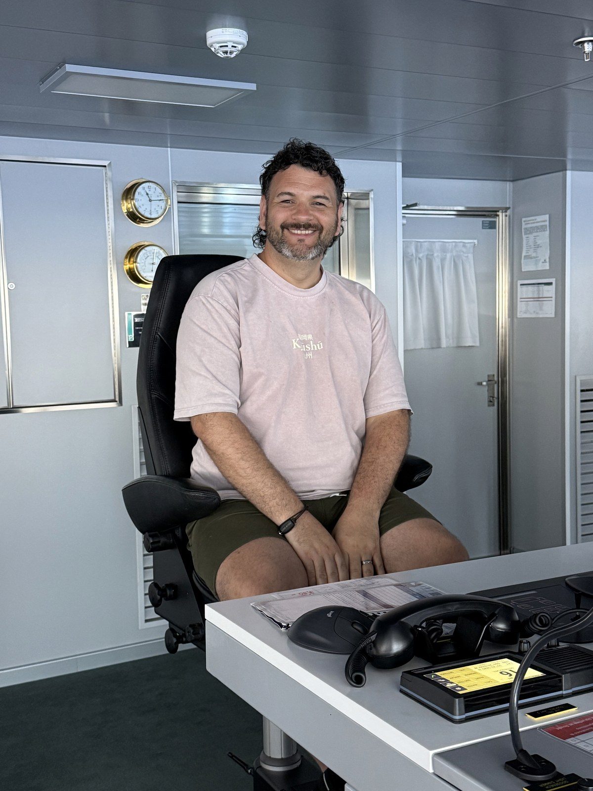 Kieran on the bridge of Resilient Lady during a bridge tour