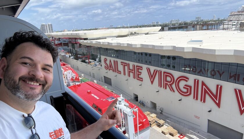 Kieran on deck by the Sail the Virgin Way sign at Terminal V, Miami