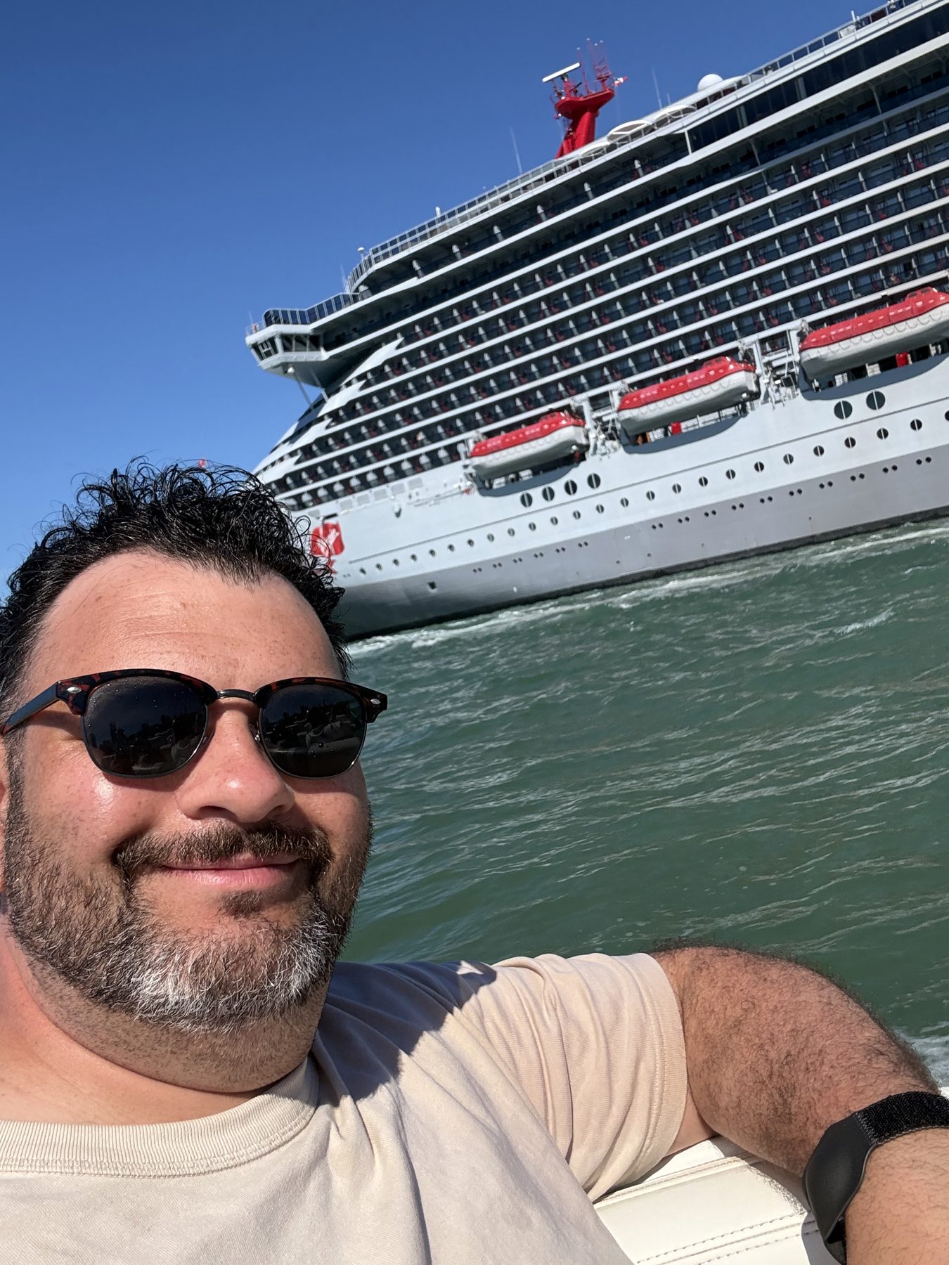 Kieran on a speedboat passing a cruise ship in Miami