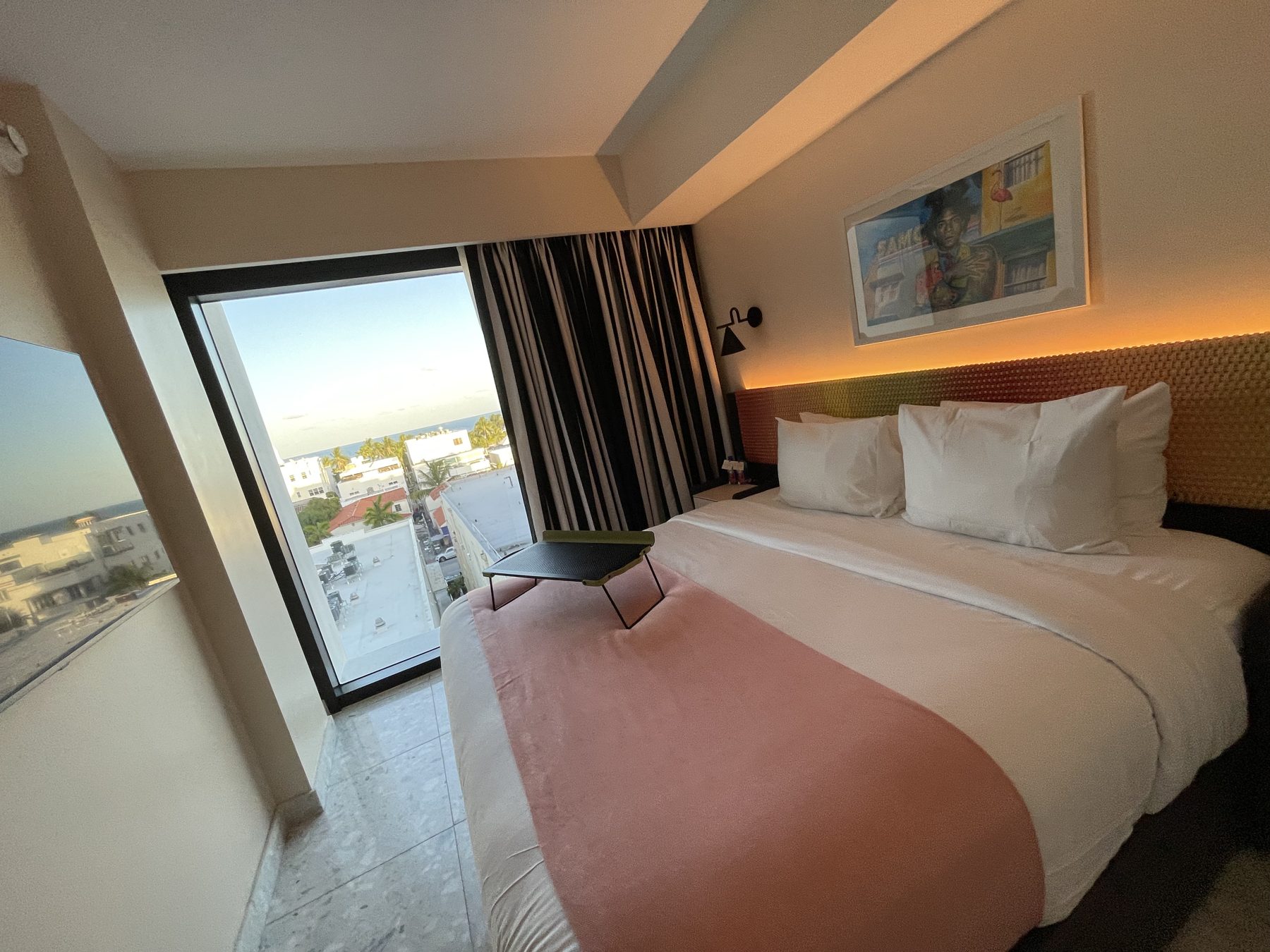 A bedroom with a balcony at Moxy South Beach