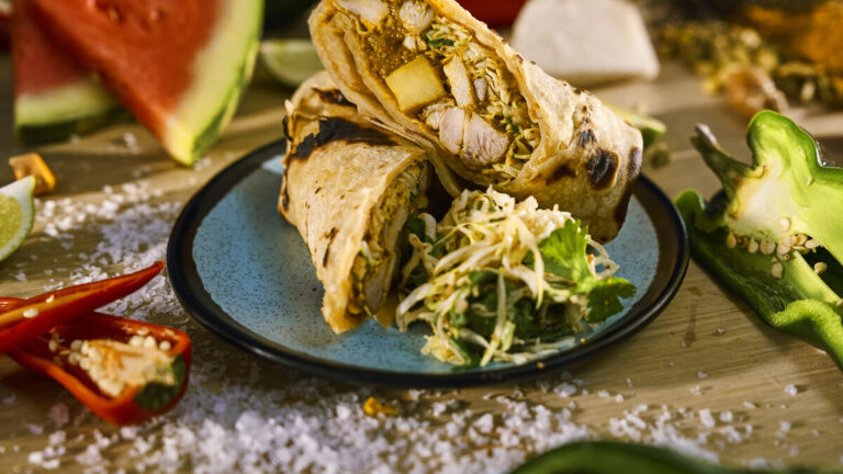 Curry chicken roti with spiced cabbage slaw from the new Beach Club at Bimini menu on Virgin Voyages