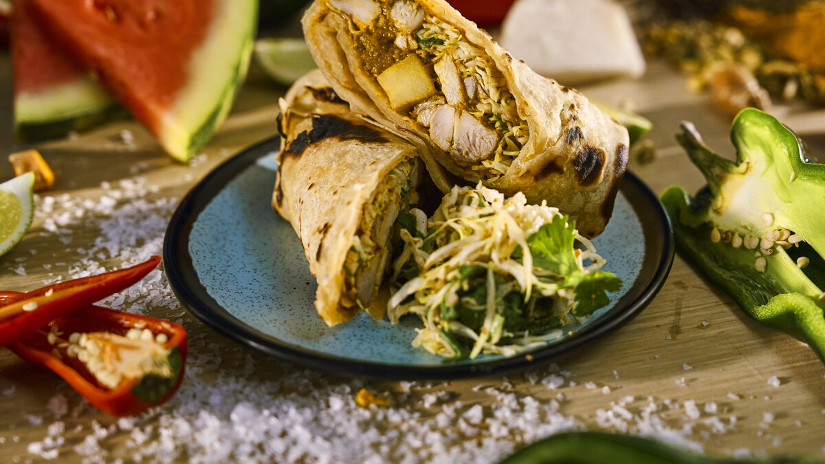 Curry chicken roti with spiced cabbage slaw from the new Beach Club at Bimini menu on Virgin Voyages