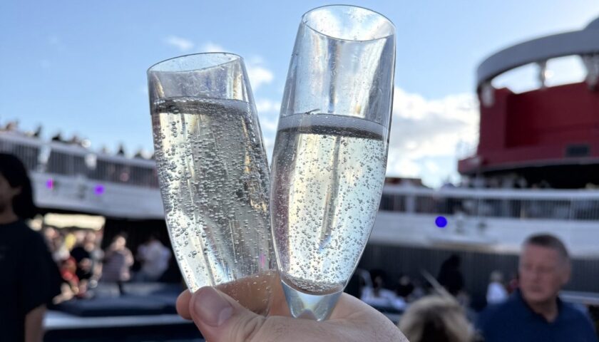 A toast with sail-away bubbles on the pool deck of Valiant Lady