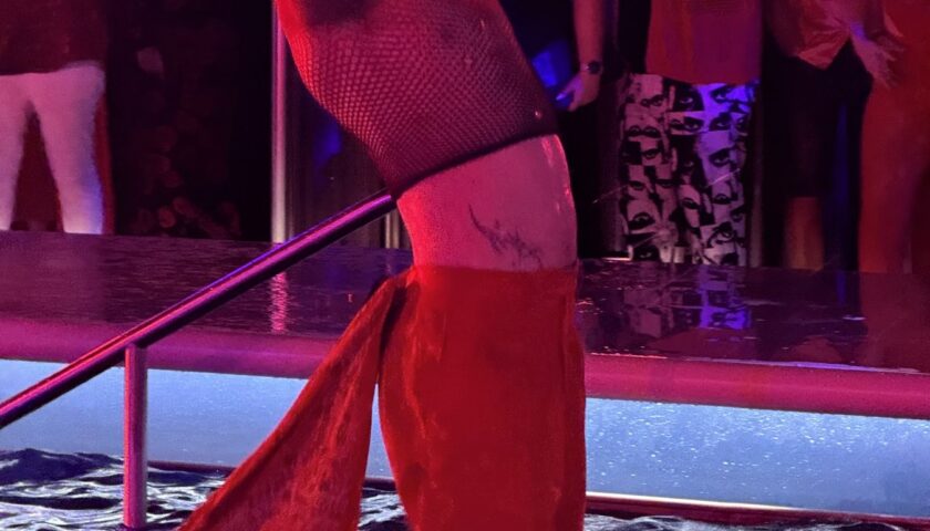 A dancer splashing through the pool at the end of Scarlet Night on Valiant Lady
