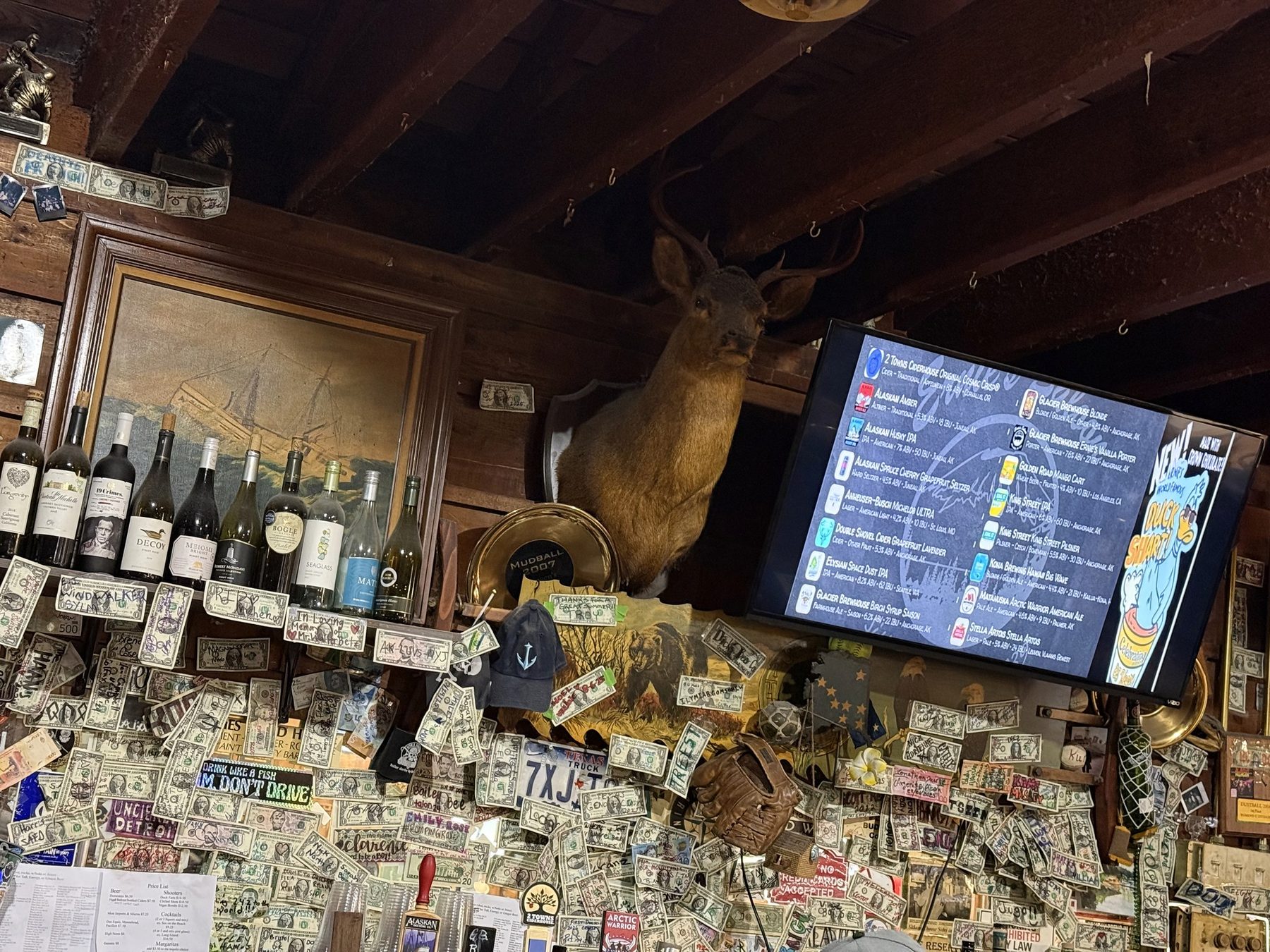 A Sitka bar wall covered in dollar bills on the Haunted Sitka tour
