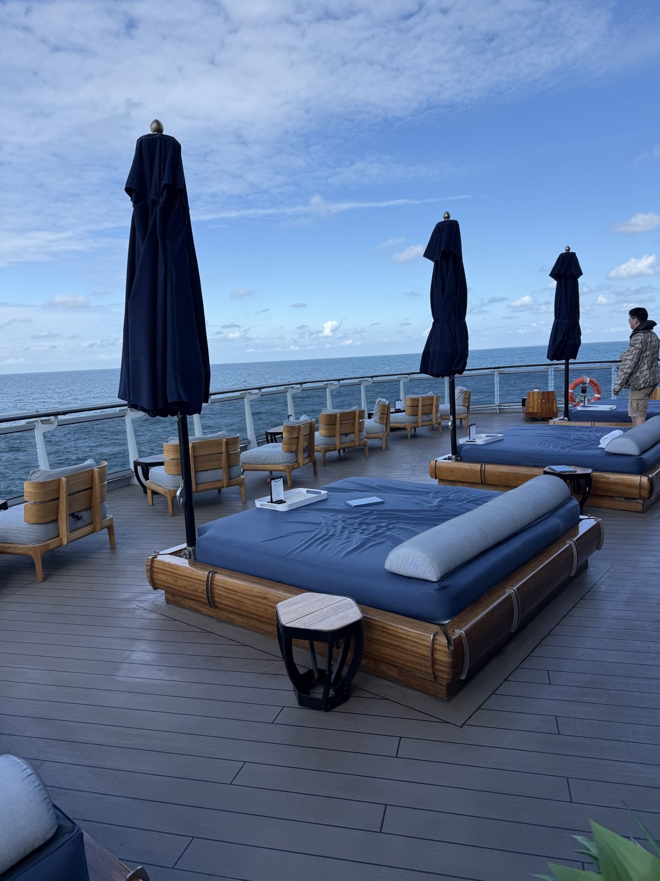 Quiet daybeds with parasols on the sun deck of Valiant Lady