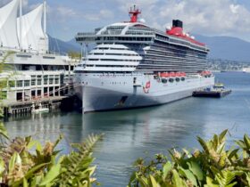 Brilliant Lady docked at Canada Place in Vancouver with mountains behind