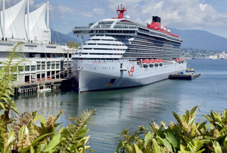 Brilliant Lady docked at Canada Place in Vancouver with mountains behind