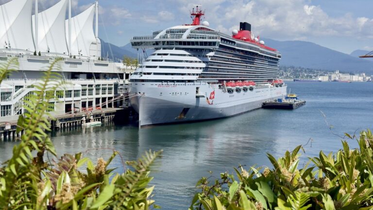 Brilliant Lady docked at Canada Place in Vancouver with mountains behind