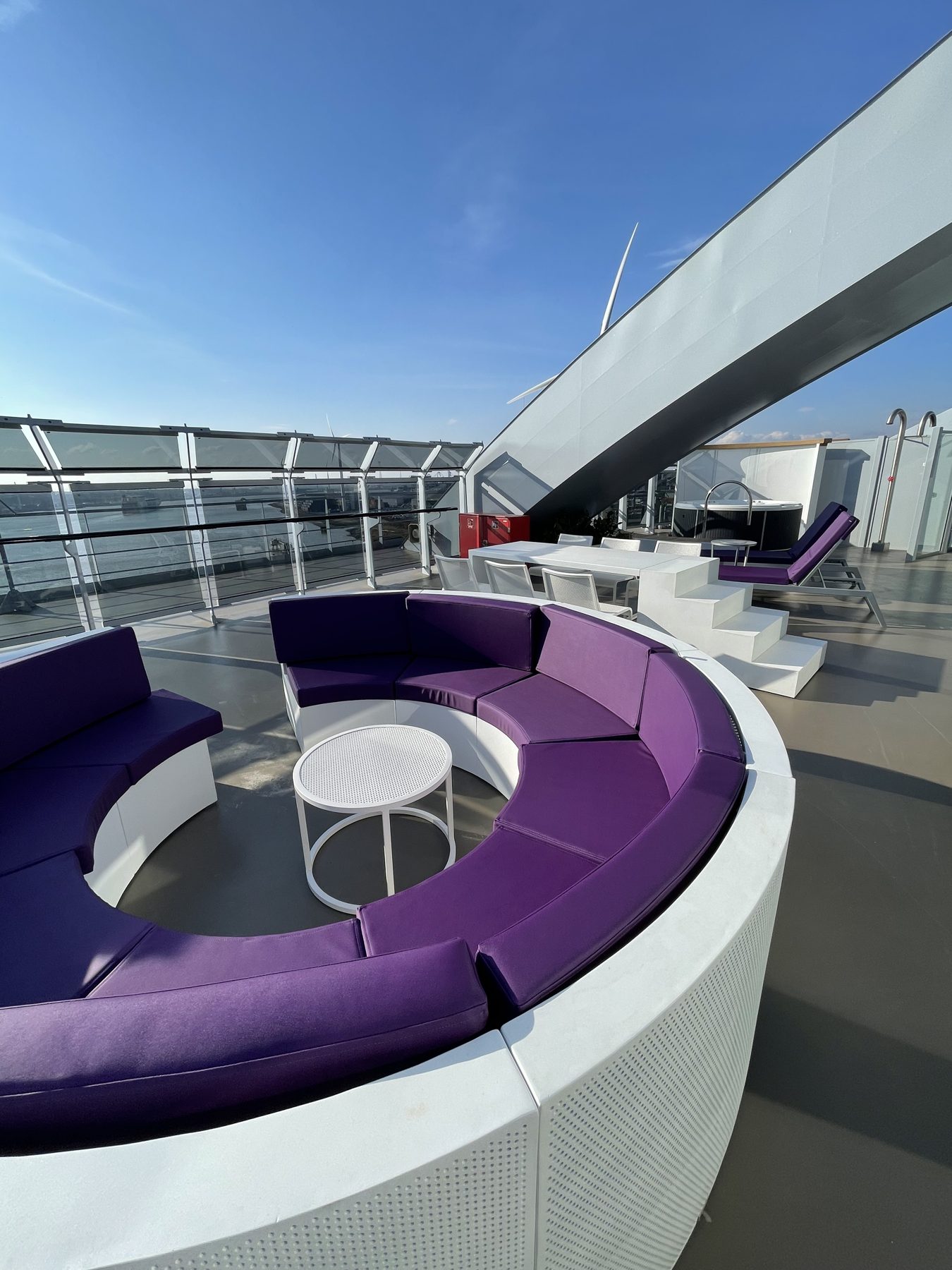The private terrace with purple seating in a Virgin Voyages Mega RockStar suite