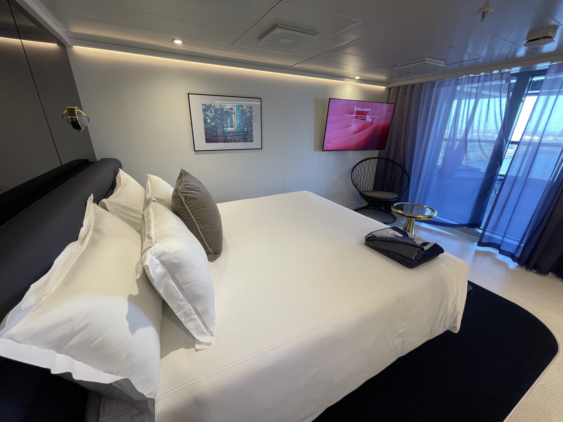 The bedroom in a Virgin Voyages RockStar Quarters suite
