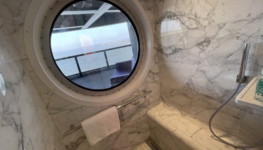 Marble shower with a porthole window in a RockStar suite