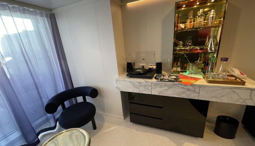 Vanity and gold bar cabinet in a Virgin Voyages RockStar suite