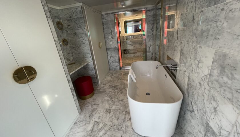 Marble bathroom with a freestanding bath in a Virgin Voyages suite