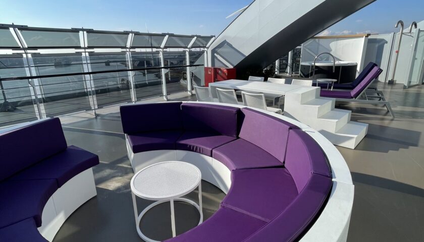 Purple curved seating on the terrace of a Virgin Voyages Massive Suite